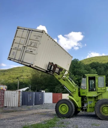 A 20ft container being carried by a forklift