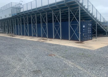 a blue custom-size storage container under school bleachers