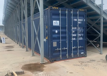 a blue custom-size storage container on school property
