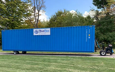 A blue storage container being accurately placed on stone using a mule device in Lycoming County, PA
